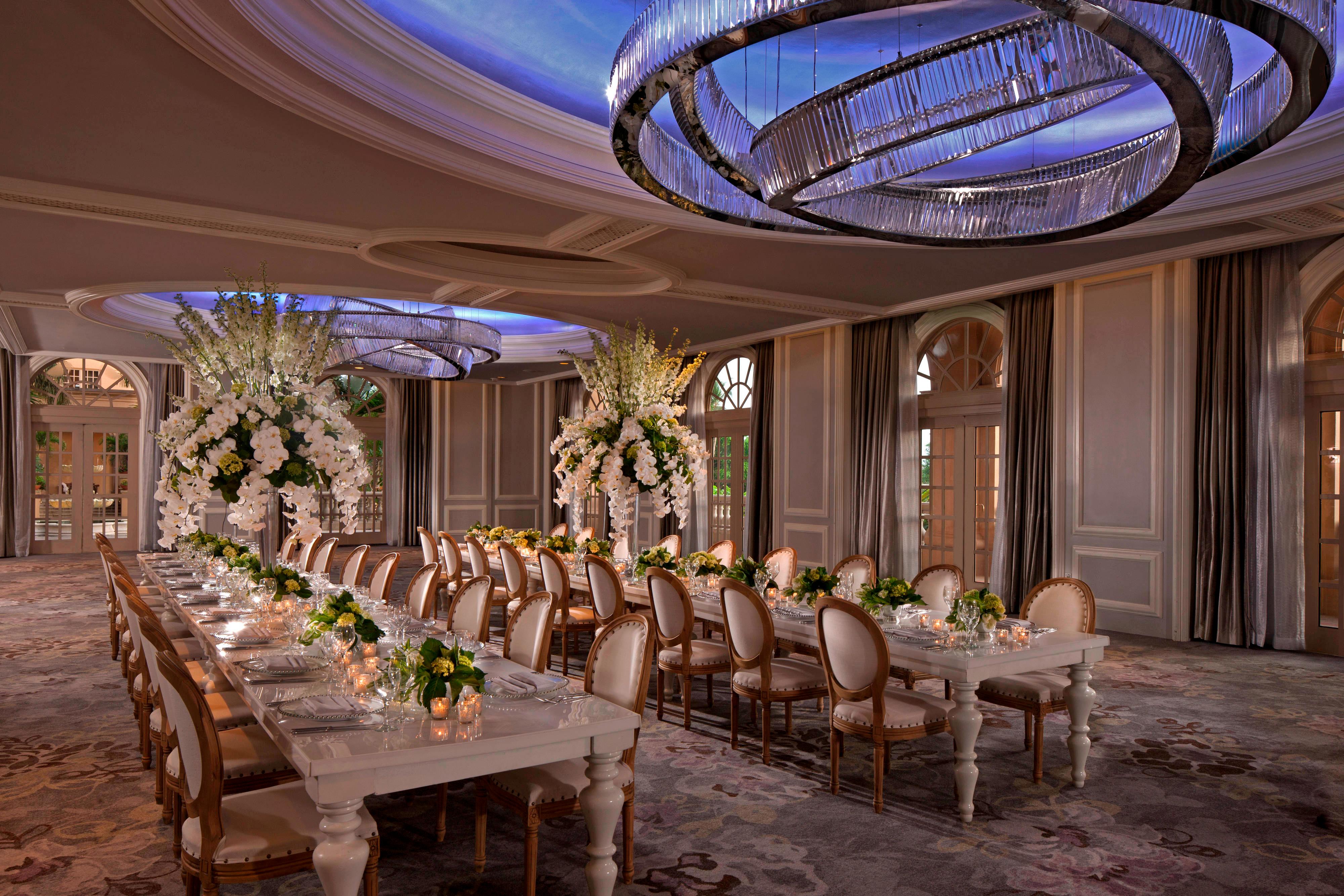 Grand ballroom with long tables and floral décor